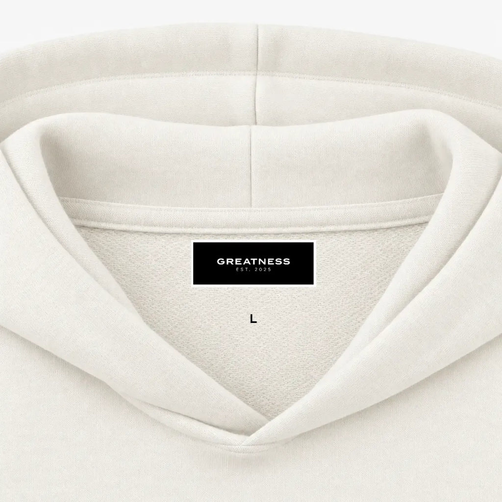 Felpa con cappuccio boxy GREATNESS Essential in off white, dettaglio etichetta interna